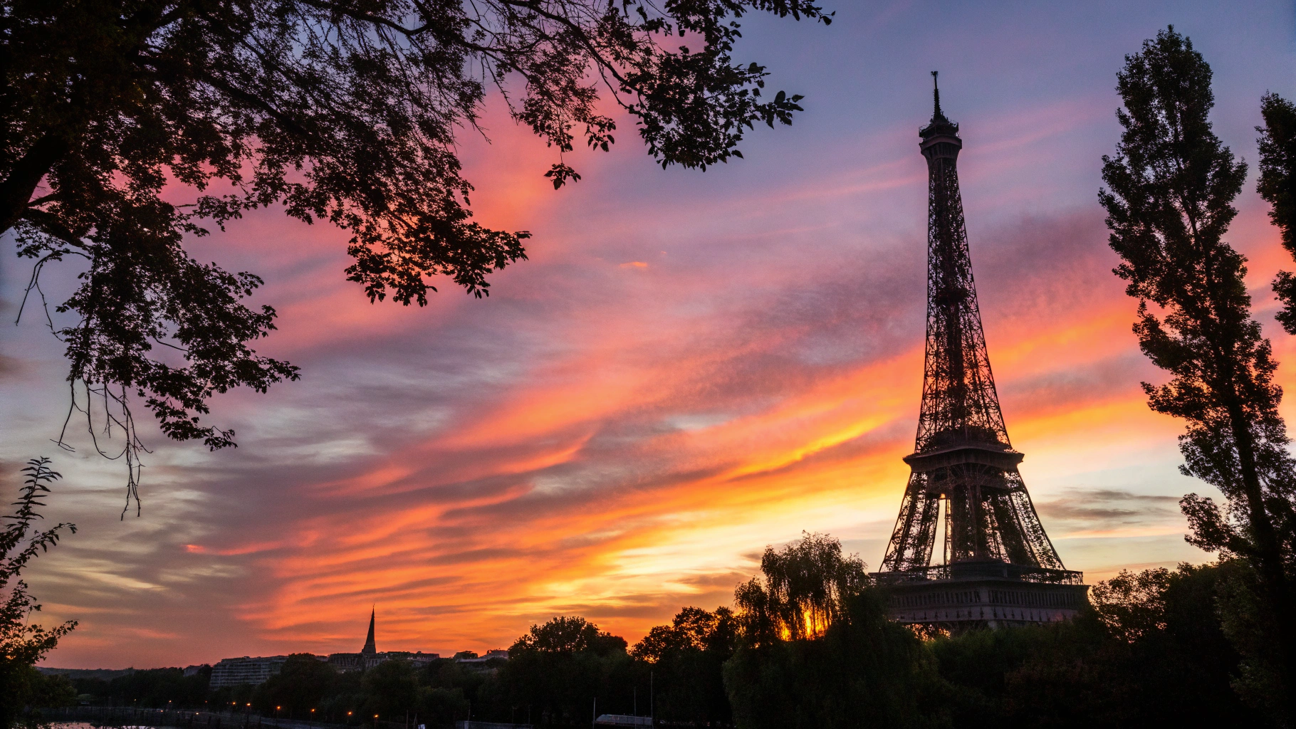 Iconic Eiffel Tower rising above the Parisian skyline at sunset