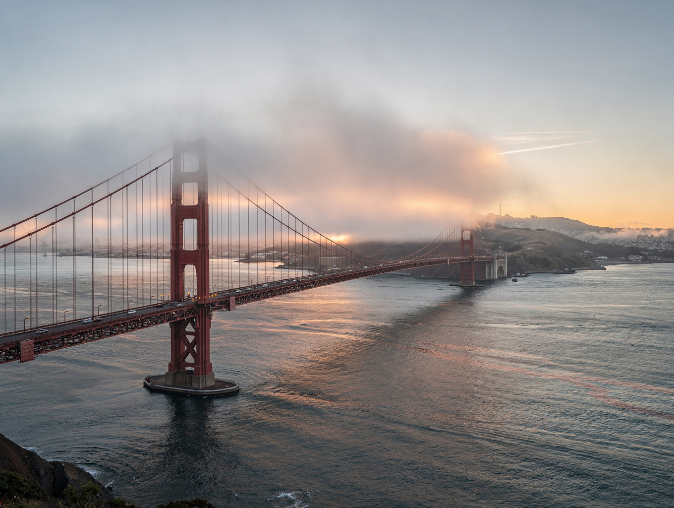 Golden Gate Bridge spans the coastal strait framed by Marin Headlands coastal wildflowers and sea fog