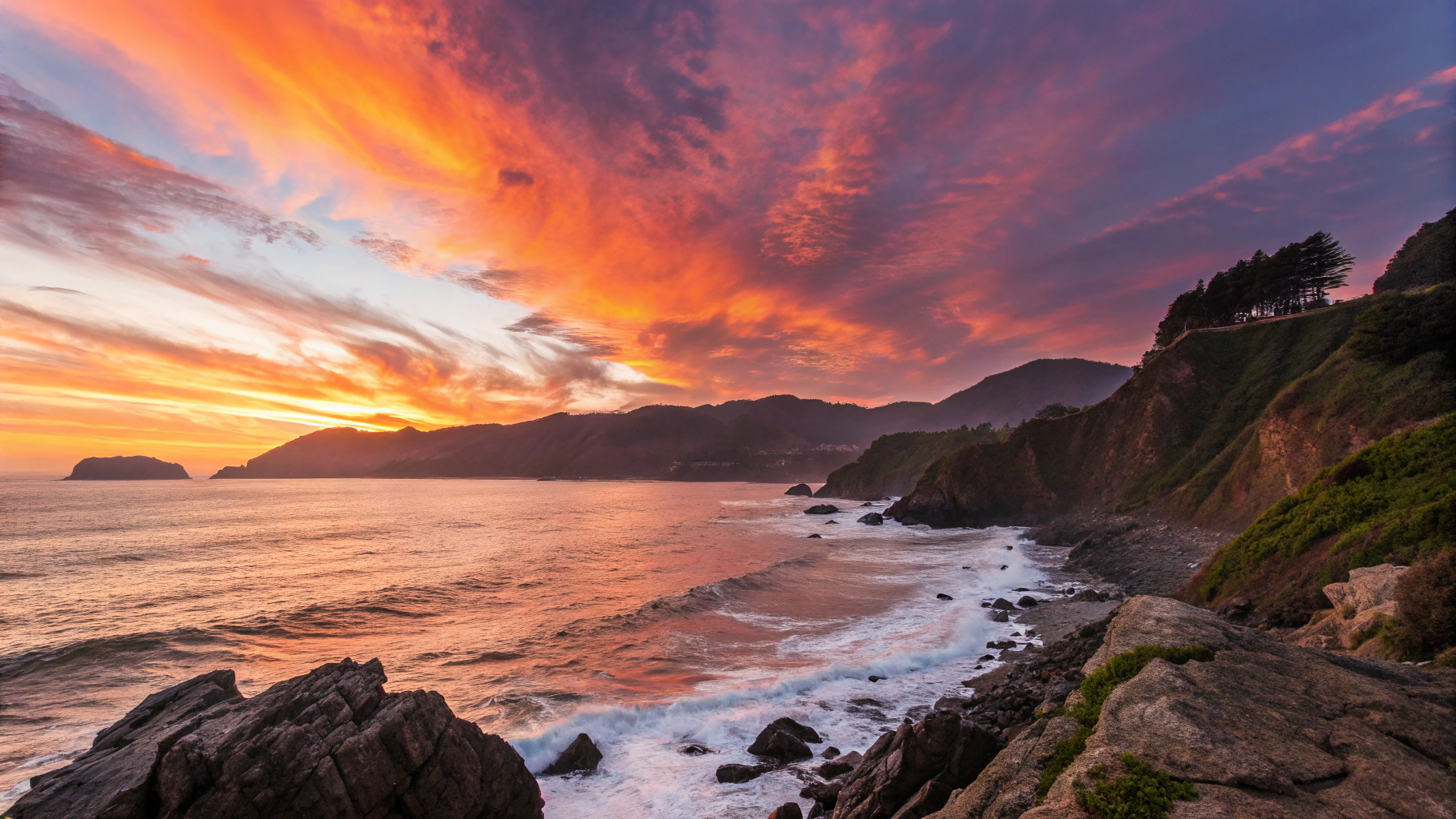 Rich golden-hour sunlight casting amber and violet reflections across calm Pacific Ocean waters