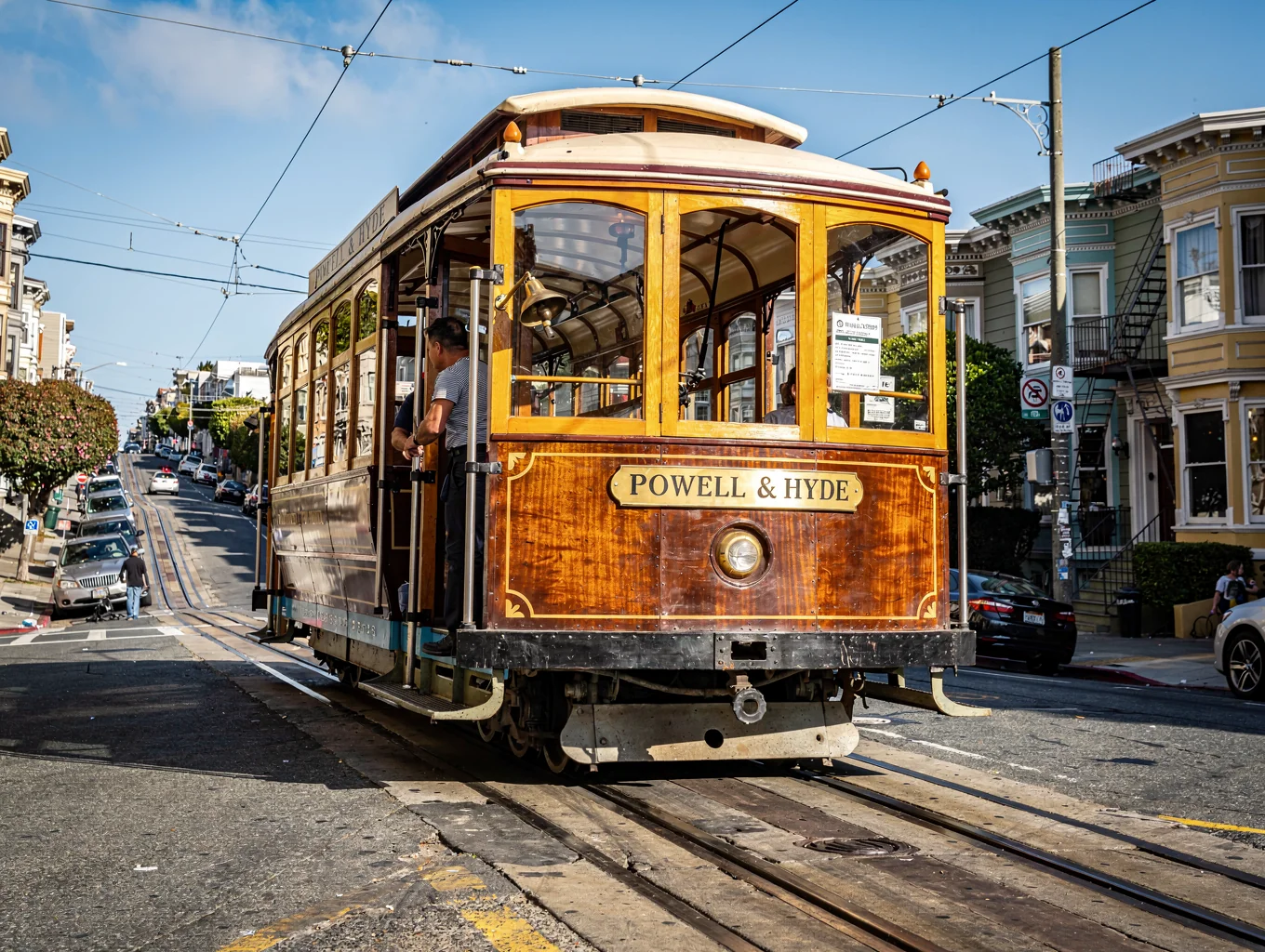 Classic Powell Street cable car cresting a steep San Francisco avenue