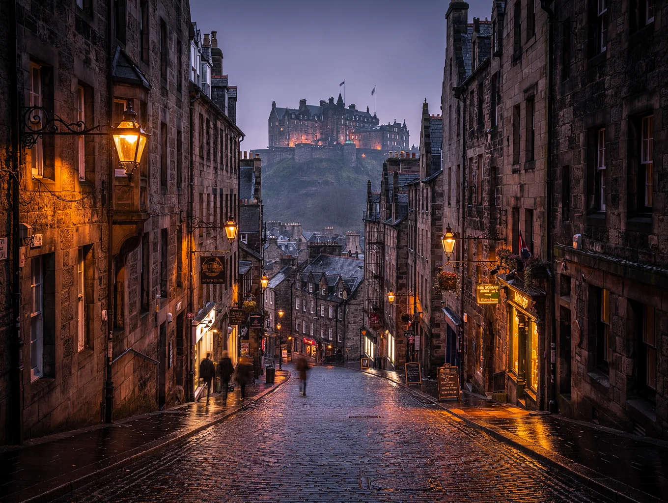 Historic stone alleyway and towers in Edinburgh Old Town at twilight