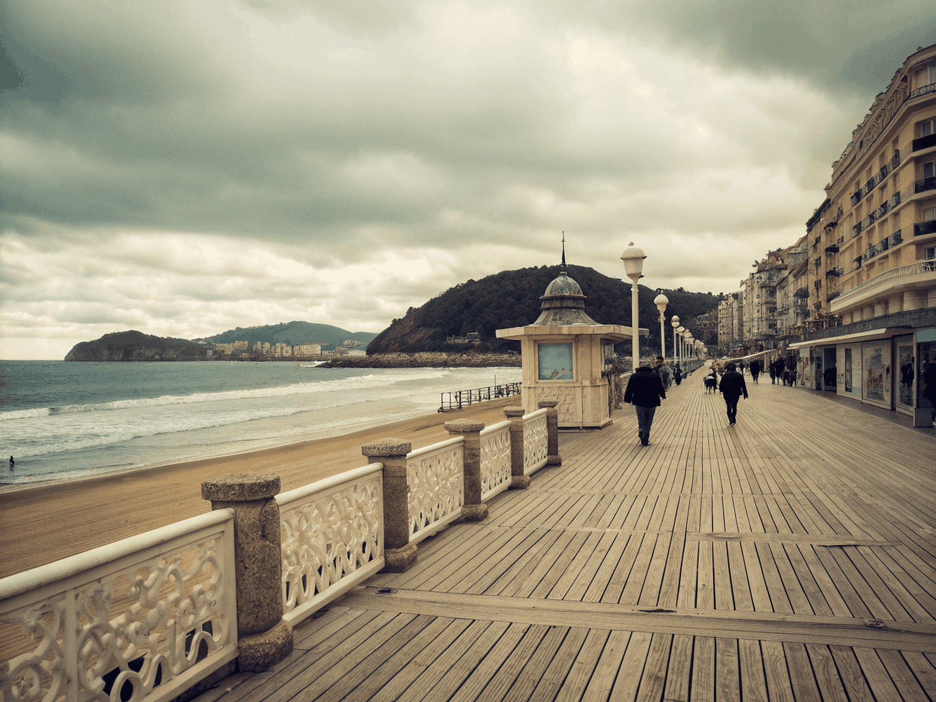 Curved ocean promenade and sandy beach in San Sebastian