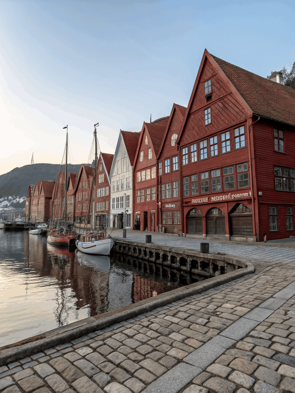 Preserved gabled Hanseatic wooden merchant houses facing the peaceful harbor waterfront of Bergen