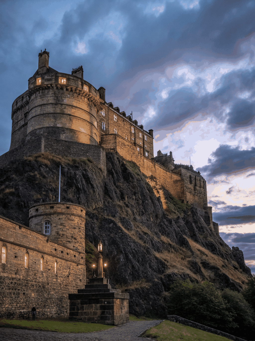 Historic Edinburgh Castle standing majestic upon dramatic volcanic rock under evening light