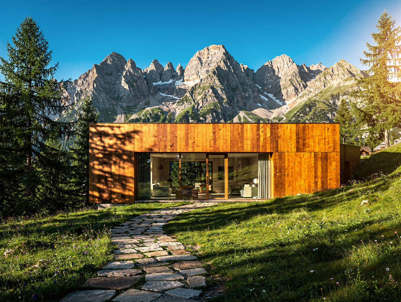 Modern timber chalet set against green Austrian alpine pastures