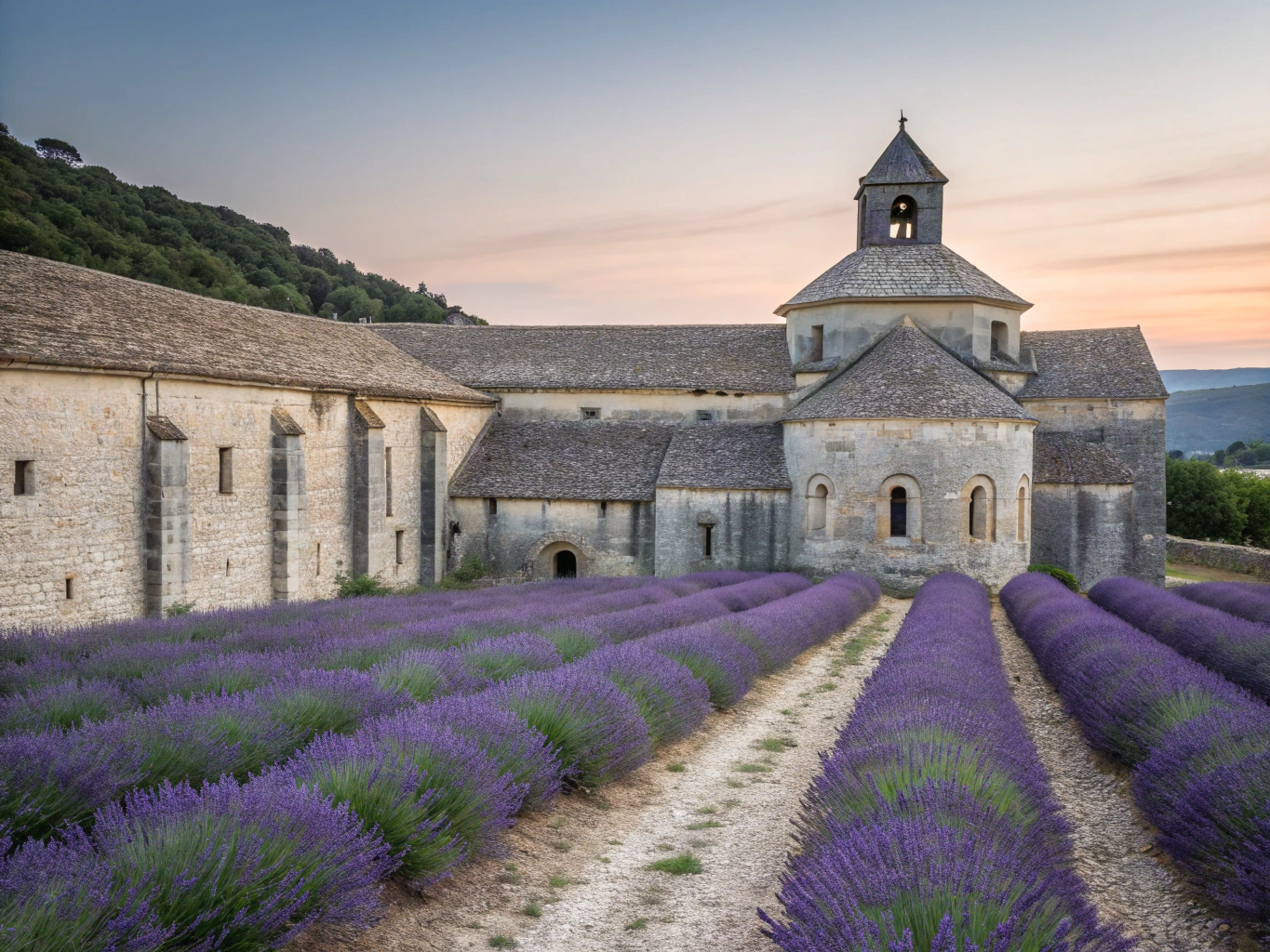 Sunlit stone bastide in Provence surrounded by lavender and cypress trees