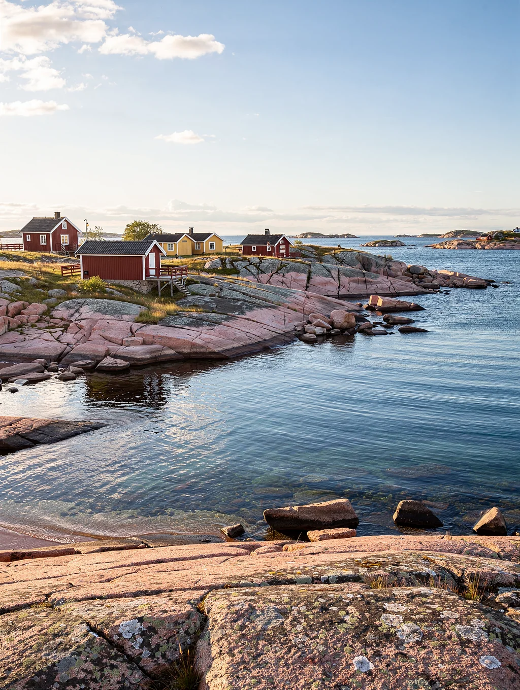 Weathered granite rocks and charming red wooden boat houses across the Gothenburg archipelago