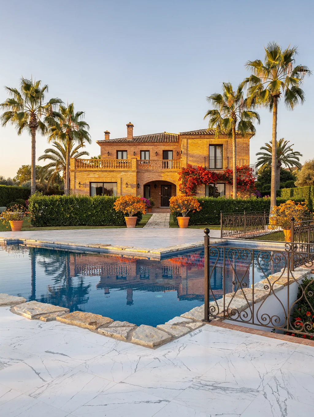 Elegant luxury beachfront resort terrace with palm trees and ocean views in Marbella