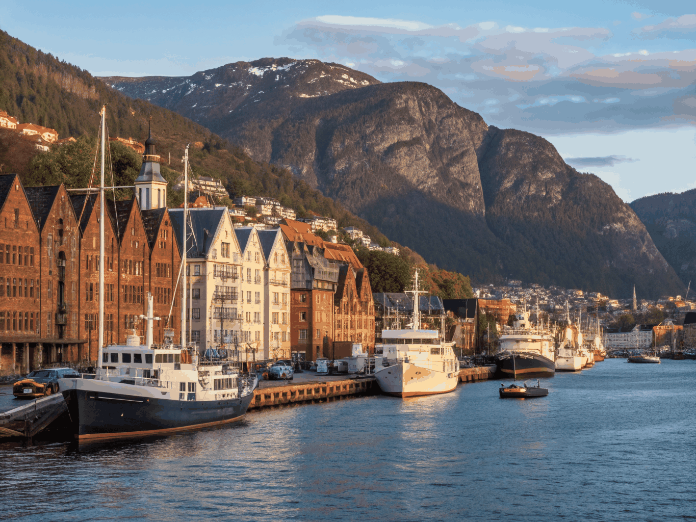 Preserved gabled Hanseatic wooden merchant houses facing the peaceful harbor waterfront of Bergen