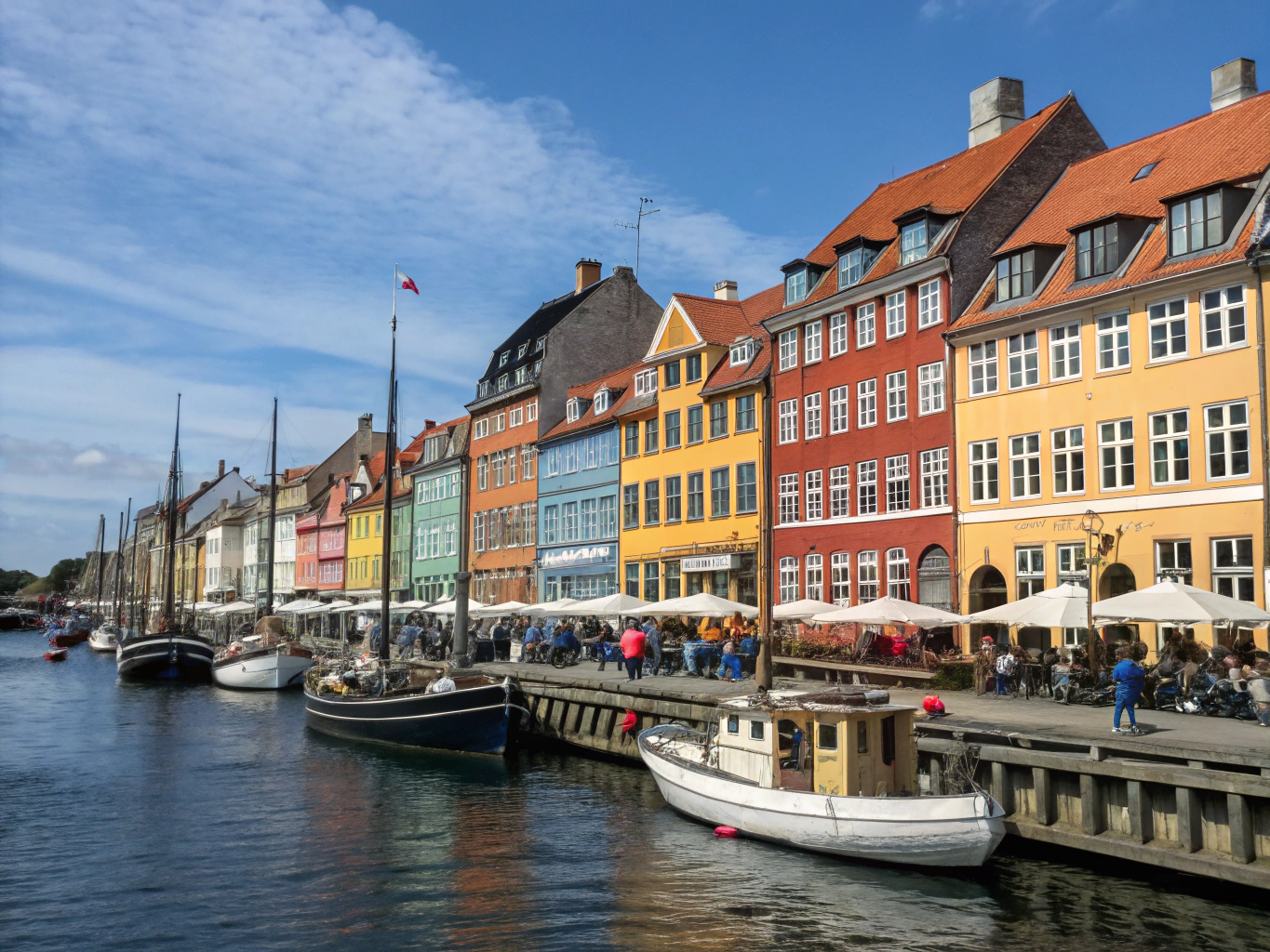 Brightly colored 17th-century townhouses and historic boats along Nyhavn canal