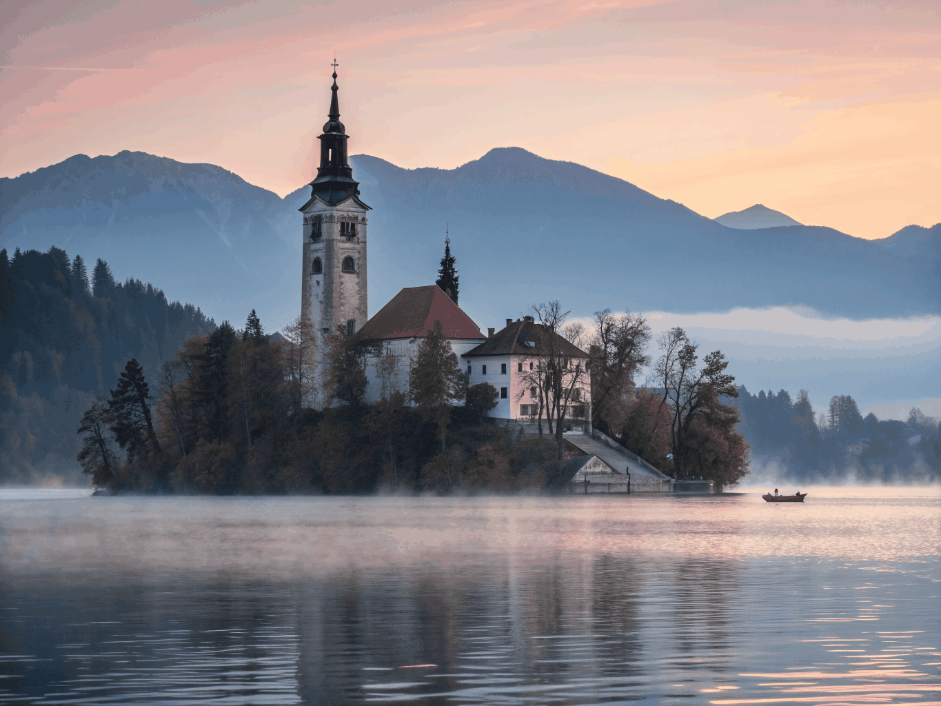 Island church in the middle of Lake Bled with Julian Alps in the background