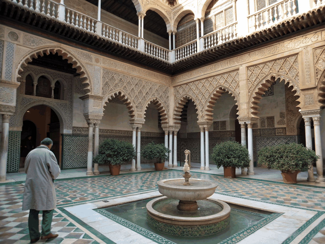 Intricate ceramic tilework and orange trees in a secluded Seville courtyard