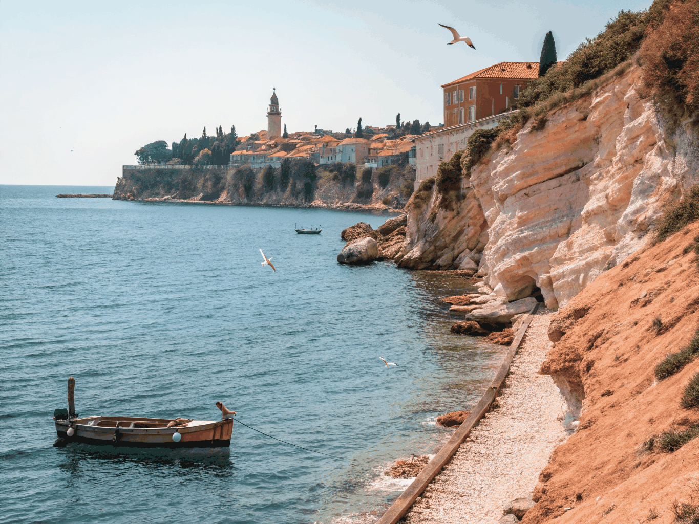 Ancient fortified stone walls above the cobalt blue Adriatic sea