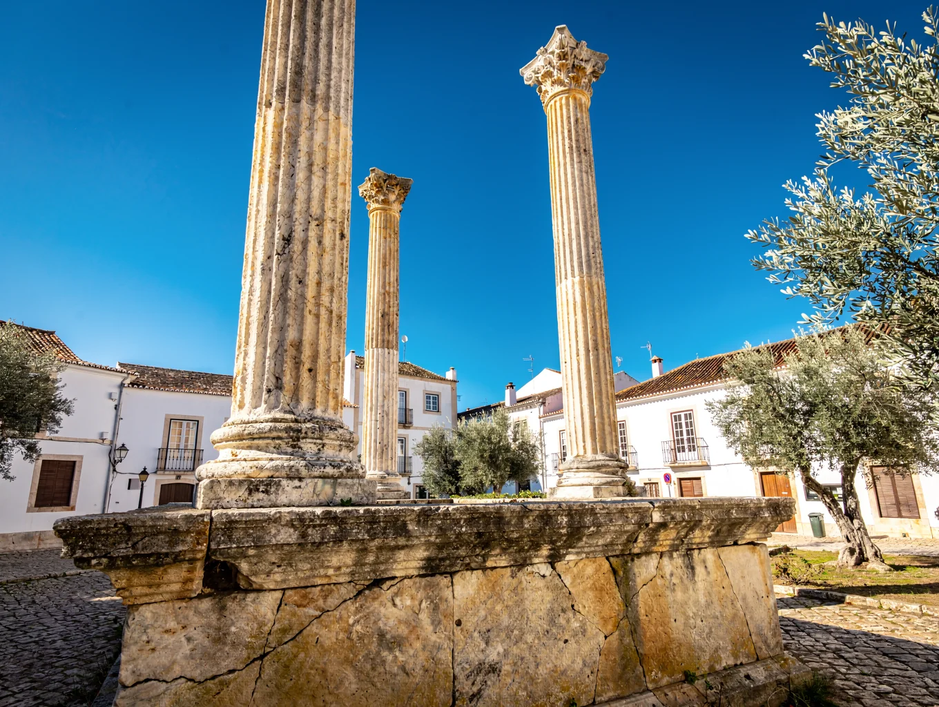 Ancient Roman colonnade standing proudly under a brilliant blue Iberian sky