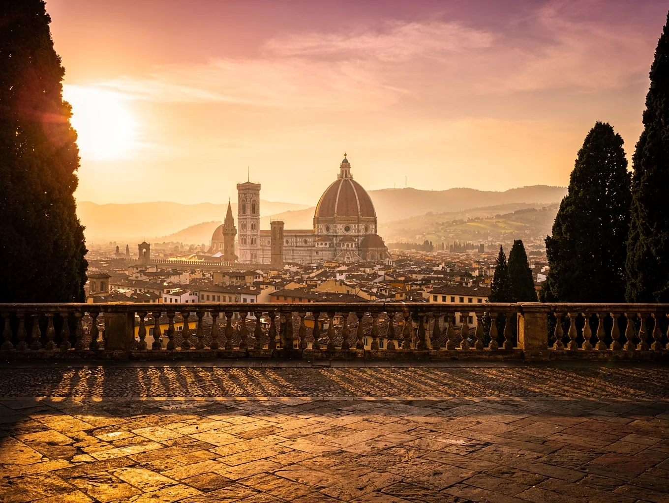 Panoramic view over Florence with the Duomo framed by cypress trees