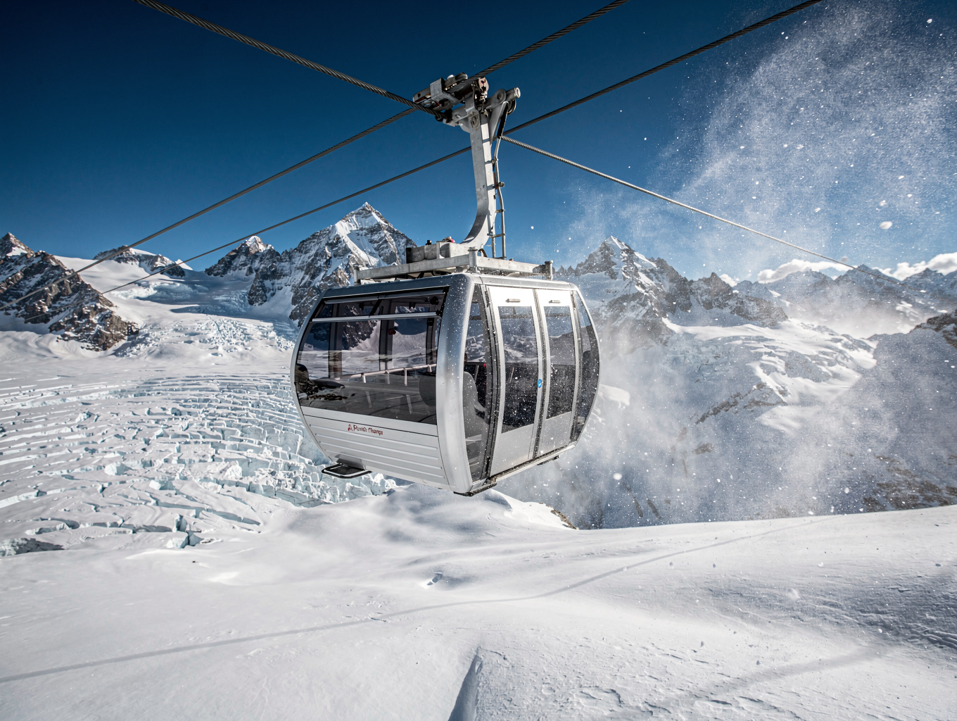 Futuristic funicular station set against sheer jagged mountain crags