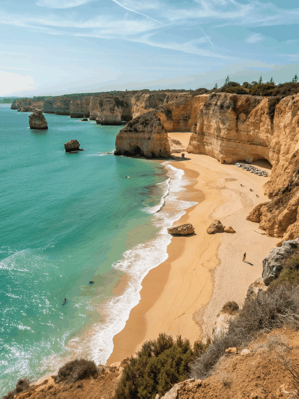 Dramatic golden sea stacks and arches standing in turquoise Atlantic ocean waters
