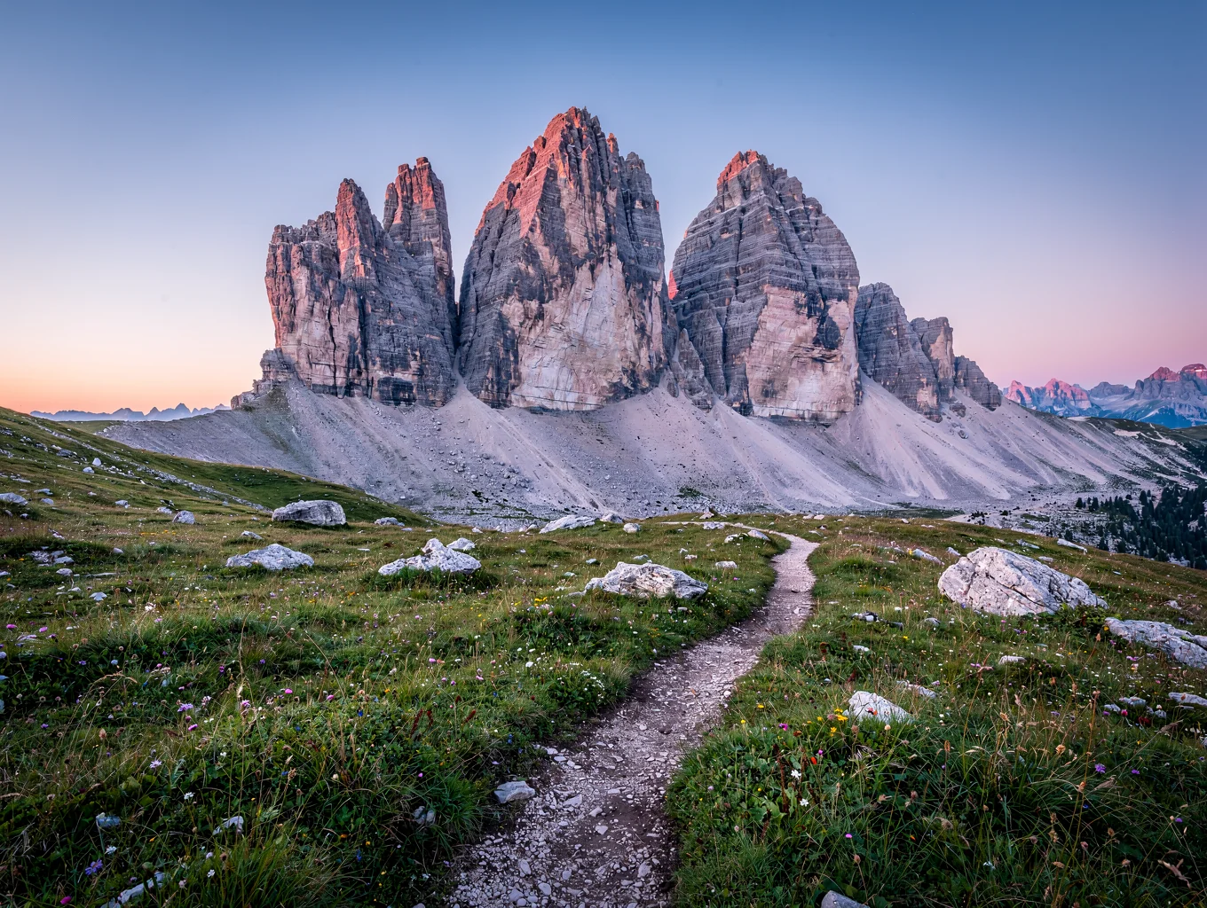 Dramatic pale limestone mountain towers of Tre Cime under crisp alpine skies