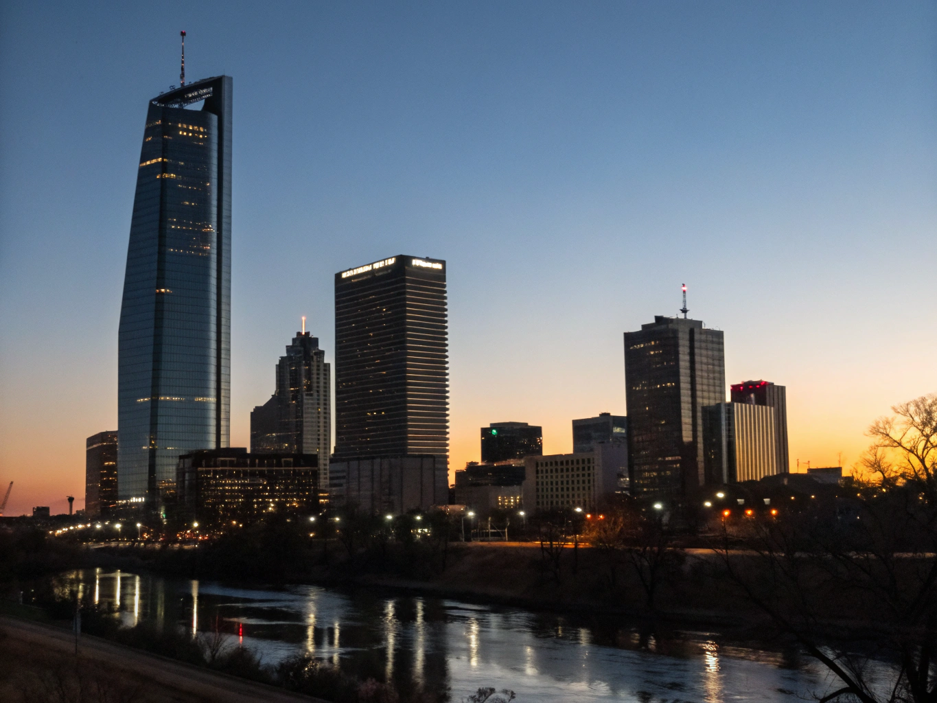 Panoramic view of Oklahoma City skyline with historic Route 66 thoroughfare in foreground
