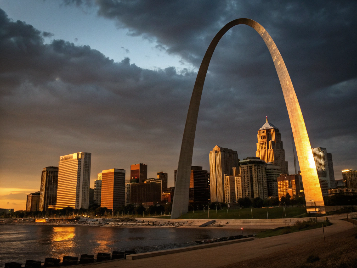 Soaring stainless steel Gateway Arch reflecting evening light by the Mississippi River