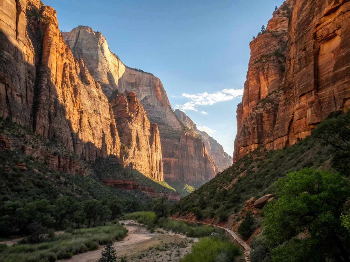 Sheer vertical red and tan sandstone cliffs overlooking Zion Canyon valley